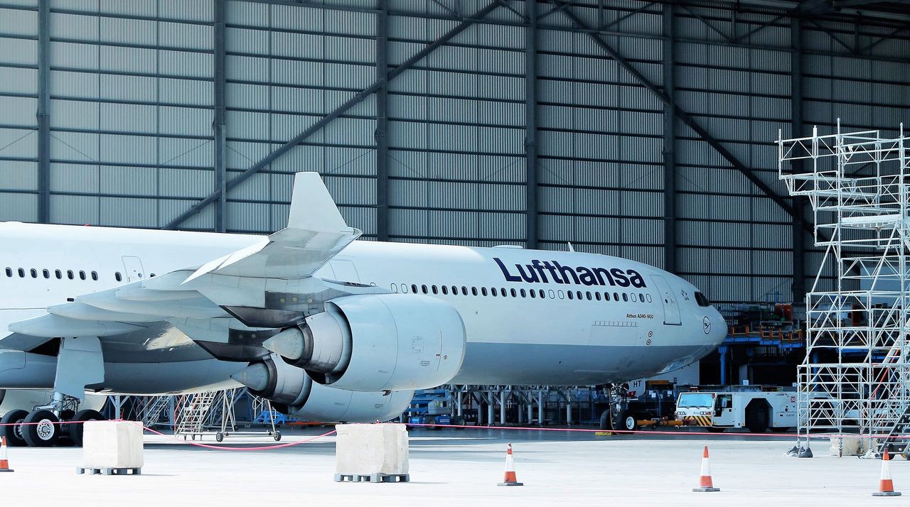 Lufthansa airplane under maintenance in hangar at Malta Airport.